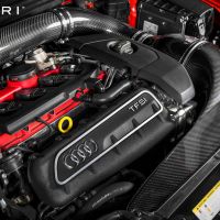 Engine with "TFSI" and Audi logo, enhanced with carbon fiber parts, “EVENTURI” text at the top left corner; displayed in a high-performance vehicle under a lifted hood.