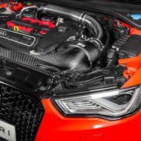 An open engine bay of an Audi car reveals a TFSI engine with Eventuri branding on the front grille in a brightly lit garage or workshop.