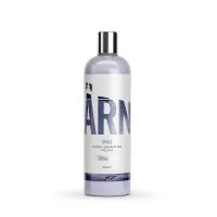 A 500ml bottle of "STJÄRNAGLOSS" gloss-enhancing polish labeled "SKÄRA," featuring silver text on a light purple body with a silver cap, standing upright within a white background.