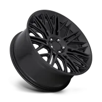 A matte black car wheel displayed on a white gradient background, featuring intricate, angular spoke designs radiating from the center hub.