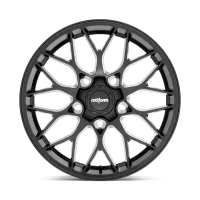 A black Rotiform wheel with an intricate, geometric spoke design is shown against a white background, highlighting the hub where the brand "rotiform" is prominently displayed.