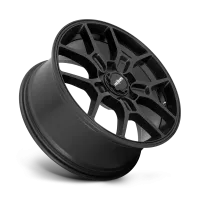 A black, multi-spoke car wheel rim is angled with the "rotiform" logo at the center. The background is a gradient of gray, highlighting the metallic finish.