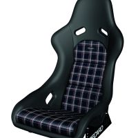 A black racing car seat with plaid fabric inserts, featuring cutouts for harness belts. The seat has the brand name "RECARO" on its metal base.