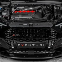 The front view of a black Audi RS3, hood open, showcasing the engine and carbon fiber air intake system with a prominent "EVENTURI" logo on the lower grille.