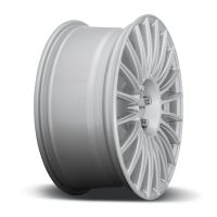 A sleek, silver car rim with multiple spokes, seen from an angled side view, resting on a white surface. Text on the hub reads: "MSW."