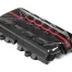 Black carbon fiber engine cover with a red, wavy stripe and intricate patterns, resting on a plain white background.
