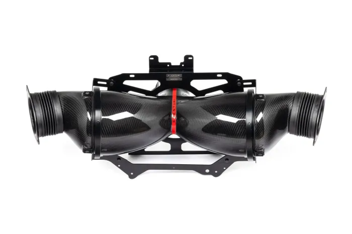 A black carbon fiber automotive intake system with dual air ducts is mounted on a black bracket, displaying the label "VENTURI" on a red band in the center.