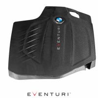 A black carbon fiber engine cover featuring a BMW logo and the word "EVENTURI." It is photographed on a white background with "EVENTURI" also written below.