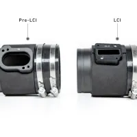 Two cylindrical automotive parts with metal clamps are labeled "Pre-LCI" (left) and "LCI" (right), showing different cut-out shapes for connectors. They are displayed on a white background.