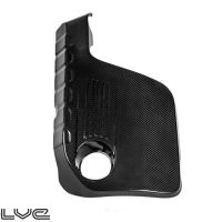 Black carbon fiber automotive component with a circular cutout, angled edges, and textured surface, placed against a white background. The word "evolve" is in the bottom left corner.