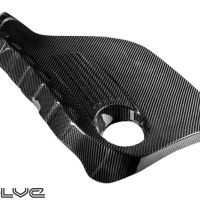 A black carbon fiber automotive part with a circular cutout sits on a white background. "Evolve" text is positioned at the bottom left corner.