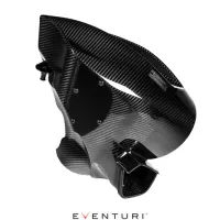 Carbon fiber intake manifold displayed against a white background; it's sleek, angular, with visible screws and mounting points. Eventuri logo present at the bottom center.