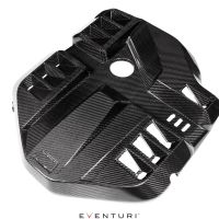 Carbon fiber engine cover with geometric patterns, vent openings, and a central circular cutout, displayed against a white background. Text: "EVENTURI."