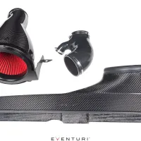 Carbon fiber car air intake, consisting of a large cone-shaped filter, an elbow pipe, and a rectangular duct, arranged on a white background. Text: "EVENTURI."