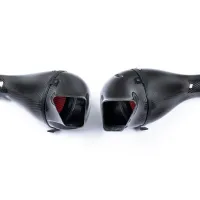 Two black, carbon-fiber air intakes with red filters are placed side by side on a white background, displaying their sleek, aerodynamic design.