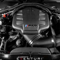 Engine bay featuring a BMW V8 engine with "M Power" branding on the cover. The Eventuri carbon fiber intake system with a red air filter is prominently visible.