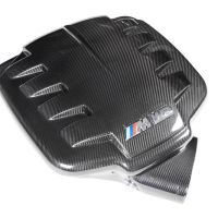 Carbon fiber engine cover labeled "M V8" with vent-like ridges, placed on a white background.