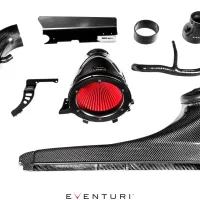 Automotive carbon fiber intake system components are arranged on a white background. A red filter, tubes, brackets, and hoses are visible. The brand "Eventuri" is printed on multiple parts and the bottom center.