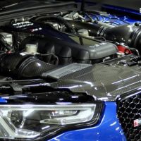 Car engine bay featuring a high-performance engine with carbon fiber components, located in a blue Audi RS5, with "EVENTURI" logo in the upper right corner.