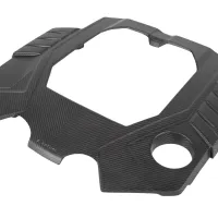 A carbon fiber engine cover features a rectangular opening and angular design accents, with "Venturi" text visible; it is displayed on a white background.