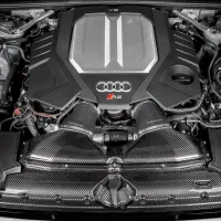 A V6 engine with an "S" badge and the Audi logo is fitted with Eventuri components, situated in a sleek car engine bay with visible wiring and metallic elements.
