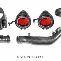 Carbon fiber automotive air intake kit with red filters displayed separately on a white background. Includes tubes, couplings, and housing components. Text reads "Eventuri" below the parts.