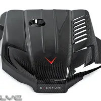 A carbon fiber car engine cover with sleek, angular designs, a small circular cut-out, red V emblem, and slotted vents, labeled "EVENTURI." The "EVOLVE" logo appears in the bottom left.