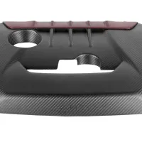 A carbon fiber engine cover features ribbed detail and a red accent at the top, with cutouts for engine components. The word "VENTURI" is visible at the bottom center.