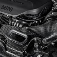 Carbon fiber air intake system situated within a MINI engine bay, surrounded by polished engine components and wiring; the word "EVENTURI™" appears in the bottom corner.
