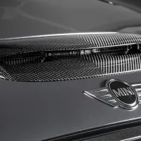 Carbon fiber air vent on a MINI car hood, viewed up close, with the logo prominently displayed below. Text "EVENTURI" appears in the bottom-left corner.
