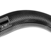 A curved carbon fiber air intake pipe features a small rectangular sensor labeled "INLET" and "RESET" in a white studio setting.