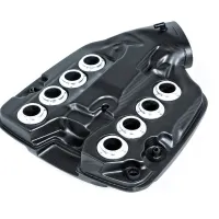 A black carbon fiber engine cover features six circular silver ports prominently on its surface, placed against a white background.