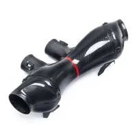 A black carbon fiber automotive intake pipe with a red band is on a white background, featuring multiple connection ports and clamps for securing.