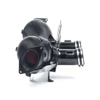 A pair of glossy black carbon fiber air intakes resting on a white background, showcasing a sleek, high-performance design with clamps and mounting brackets.