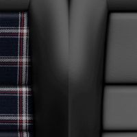 Two car seats, one with tartan fabric and the other with plain black leather, both featuring "RECARO" logos in a vehicle interior.