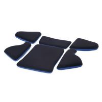 Six black foam pads of varying shapes, with light blue undersides, are arranged in a scattered formation on a white background.