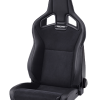 A black Recaro car racing seat is positioned upright with a high backrest and padded cushions, set against a plain white background.