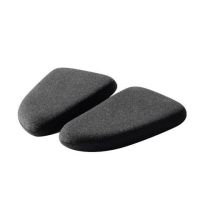 Two dark gray, triangular foam pads lie next to each other on a white background, appearing soft and slightly curved for ergonomic support.