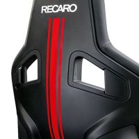 A black racing seat with red stripes and the text "RECARO" printed in white, viewed from the back in a well-lit studio setting.