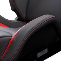Racing car seat with grey and red upholstery, detailed with red stitching, positioned in a vehicle interior. Plaque at the base of the seat reads, "RECARO."