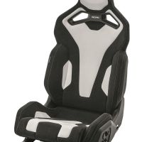 A black and white racing car seat is shown in a studio setting. The seat features ergonomic padding, integrated headrest, and the brand name "RECARO" written on the headrest area.