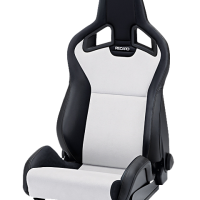A black and white racing car seat with "RECARO" text on the headrest is stationary against a white background.
