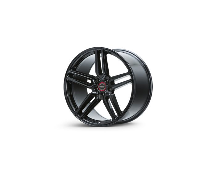 A black, five-spoke alloy wheel is standing upright on a white background. The center cap features a red ring with the text: "Tuff A.T. Wheels."