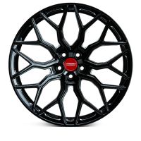 A black, multi-spoke alloy wheel is displayed against a white background. Text on the red center cap reads, "Vossen Forged."