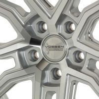 Silver alloy wheel displaying a geometric, polished design with five dual spokes. Embossed center cap reads "VOSSEN HYBRID FORGED." Wheel is cleanly presented on a neutral background.