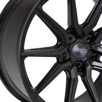 A black alloy wheel features intricate spoke design and the center cap is labeled "VOSSEN HYBRID FORGED." The wheel is photographed against a white background.