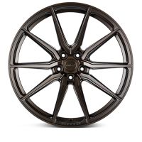 A bronze alloy wheel with a multi-spoke design, resting against a white background. Center hub text reads: "VOSSEN FORGED MIAMI, USA."