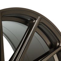 A close-up view of a metallic, matte brown wheel rim with a multi-spoke design set against a simple white background.