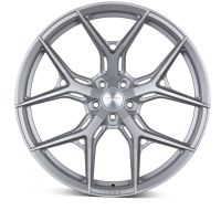 A silver alloy wheel with intricate, branching spokes rests against a plain white background. The center hub reads, "VOSSEN FORGED."