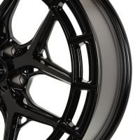 Black alloy wheel with intricate spoke design, displaying brand logo "VOSSEN HYBRID FORGED" at the center, situated against a plain white background.